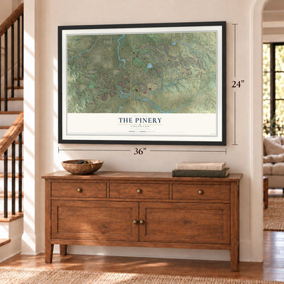The Pinery, Colorado map, 24 x 36 inch print in a black frame above a dresser by a staircase