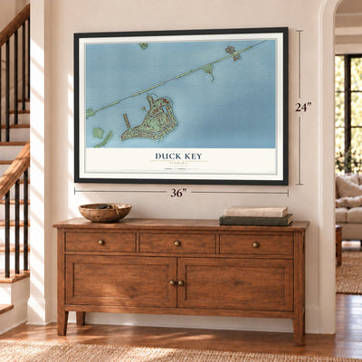 Duck Key, Florida map, 24 x 36 inch print in a black frame above a dresser by a staircase