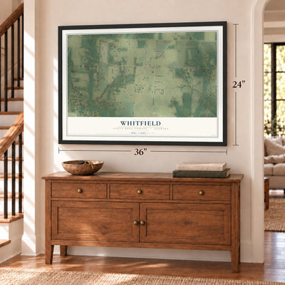 Whitfield, Santa Rosa County, Florida map, 24 x 36 inch print in a black frame above a dresser by a staircase
