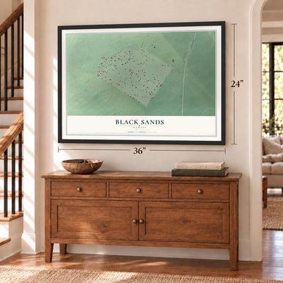 Black Sands, Hawaii map, 24 x 36 inch print in a black frame above a dresser by a staircase