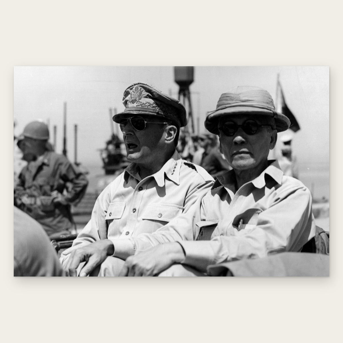 General Douglas MacArthur in sunglasses and his braided cap sits beside Philippine President Sergio Osmeña, who wears a pith helmet and round dark glasses, in a jeep at Tacloban, Leyte, in October 1944, restored vintage photo print