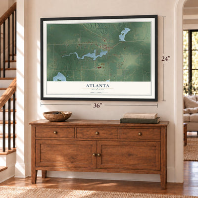 Atlanta, Michigan map, 24 x 36 inch print in a black frame above a dresser by a staircase