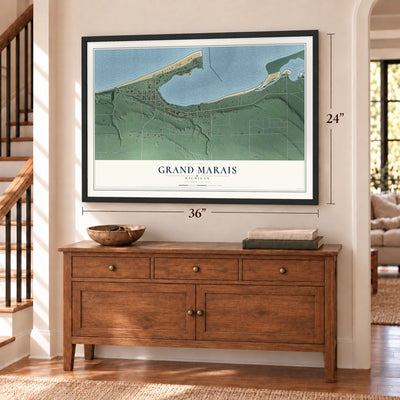 Grand Marais, Michigan map, 24 x 36 inch print in a black frame above a dresser by a staircase