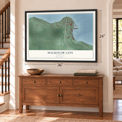 Mackinaw City, Michigan map, 24 x 36 inch print in a black frame above a dresser by a staircase