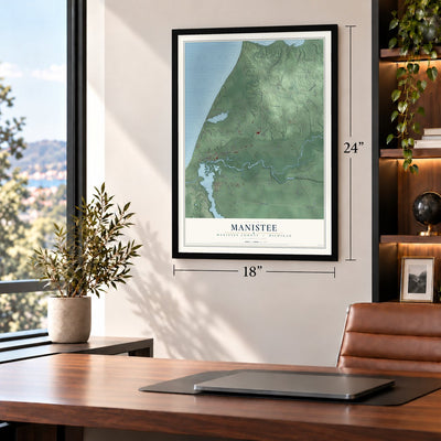 Manistee, Manistee County, Michigan map, 18 x 24 inch print in a black frame in a home office