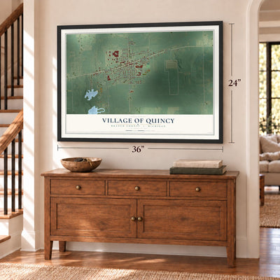 Quincy, Michigan map, 24 x 36 inch print in a black frame above a dresser by a staircase