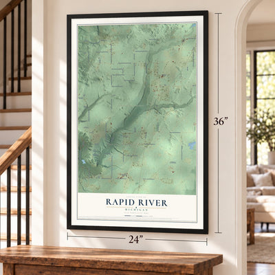 Rapid River, Michigan map, 24 x 36 inch print in a black frame by a staircase