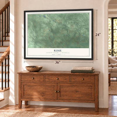 Rose, Ogemaw County, Michigan map, 24 x 36 inch print in a black frame above a dresser by a staircase