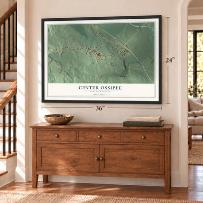 Center Ossipee, New Hampshire map, 24 x 36 inch print in a black frame above a dresser by a staircase