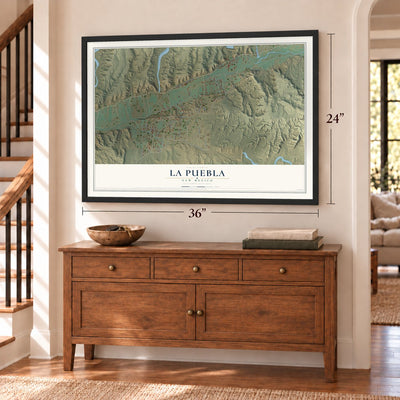La Puebla, New Mexico map, 24 x 36 inch print in a black frame above a dresser by a staircase