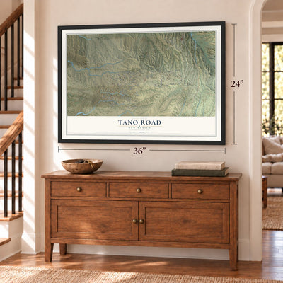 Tano Road, New Mexico map, 24 x 36 inch print in a black frame above a dresser by a staircase