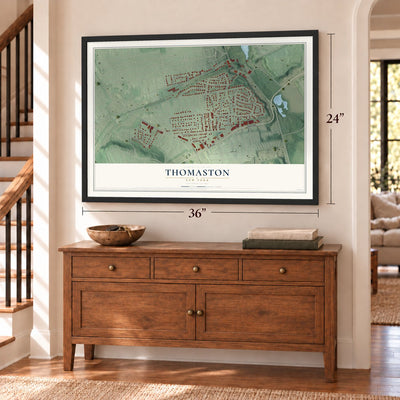 Thomaston, New York map, 24 x 36 inch print in a black frame above a dresser by a staircase