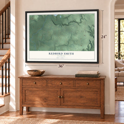 Redbird Smith, Oklahoma map, 24 x 36 inch print in a black frame above a dresser by a staircase