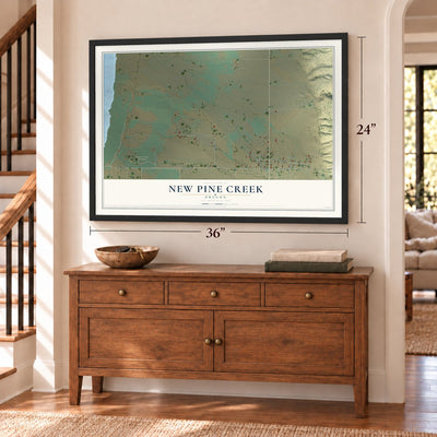 New Pine Creek, Oregon map, 24 x 36 inch print in a black frame above a dresser by a staircase