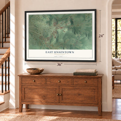 East Uniontown, Pennsylvania map, 24 x 36 inch print in a black frame above a dresser by a staircase