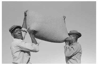 Laborers Lifting Rice Bag in Crowley Louisiana 1938 - Available at KNOWOL