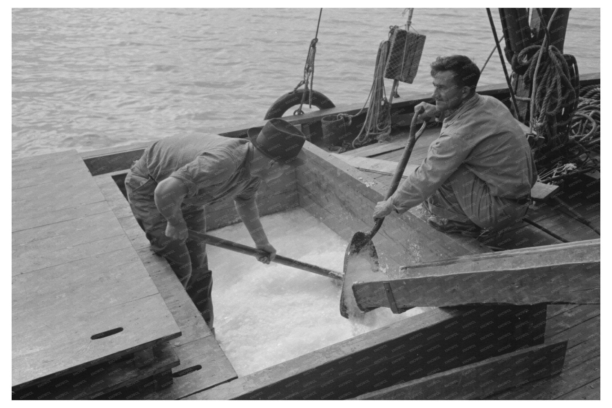 Loading Shaved Ice on Shrimp Boat Morgan City 1938 - Available at KNOWOL