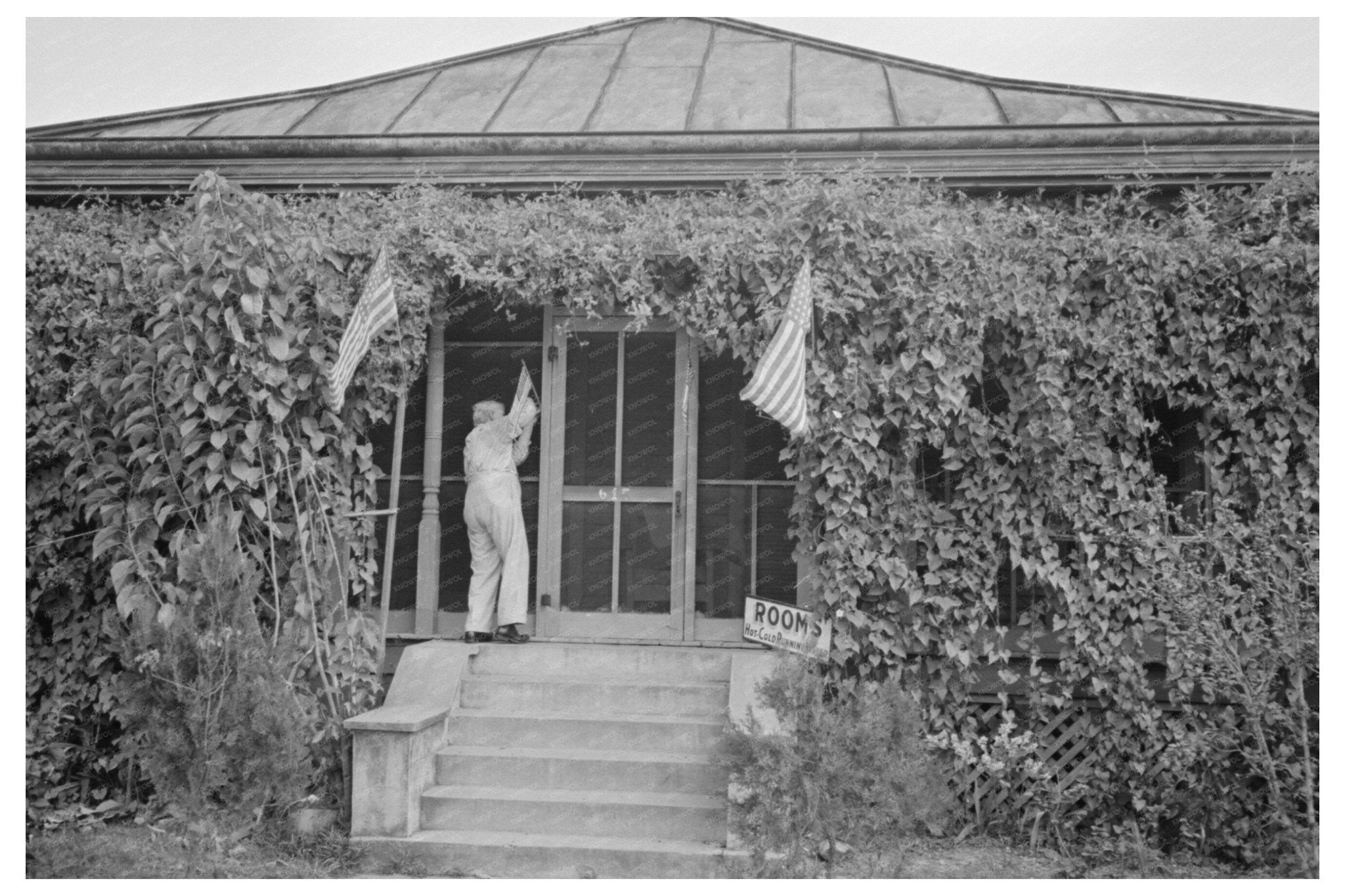 Man Raising Flag in Donaldsonville Louisiana November 1938 - Available at KNOWOL