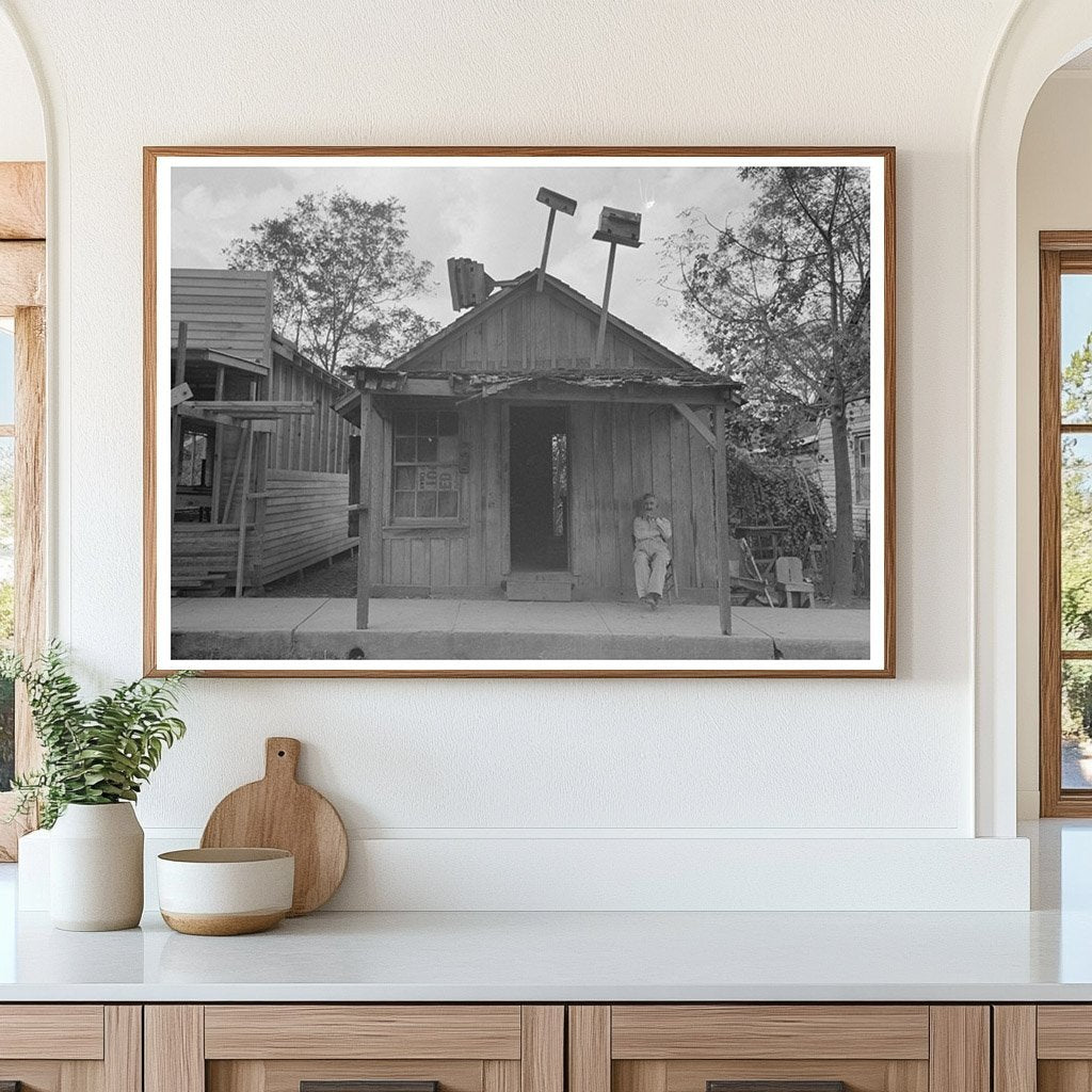 Man Seated Outside Store in Opelousas Louisiana 1938 - Available at KNOWOL