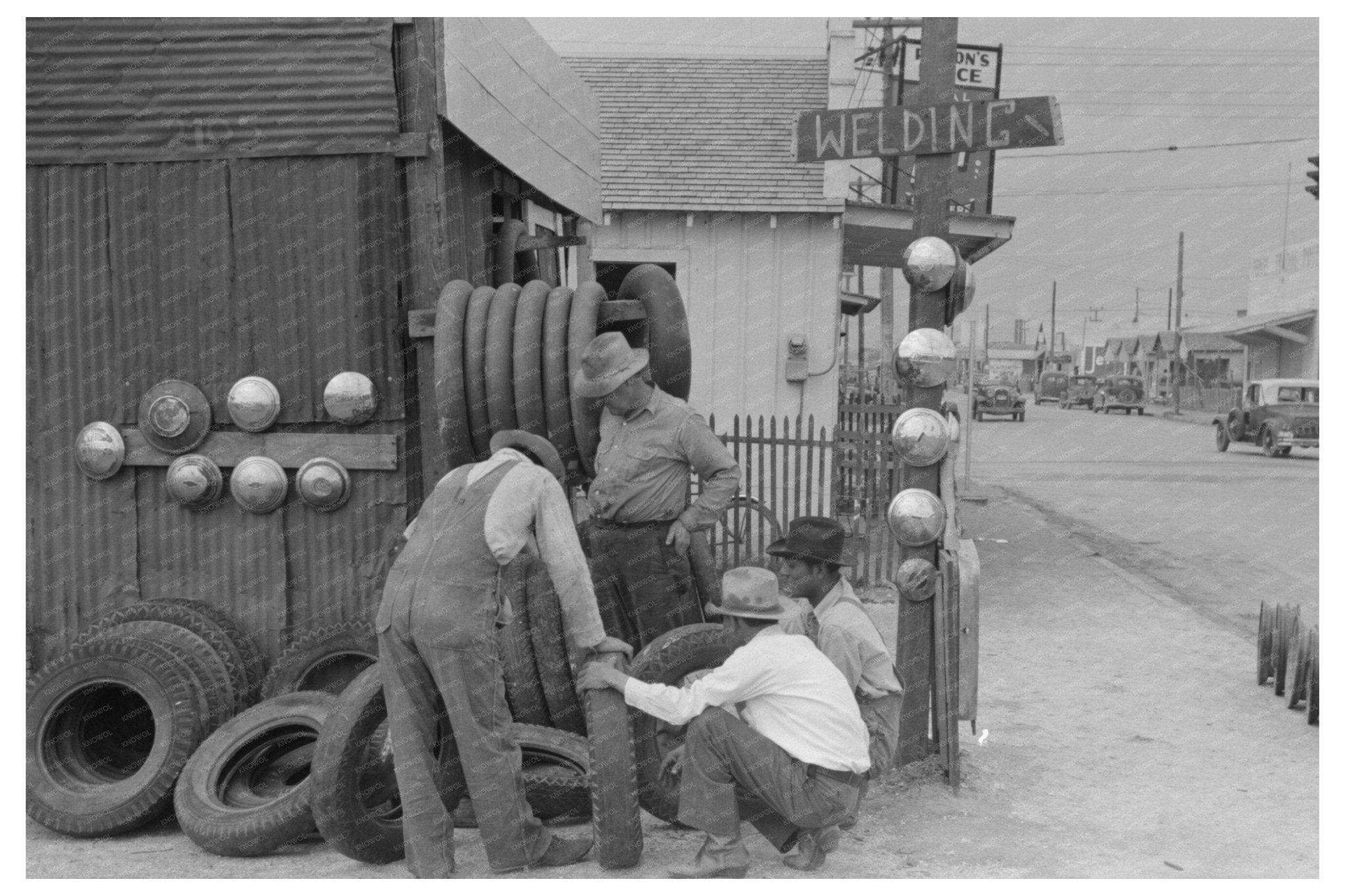 Men Inspect Secondhand Tires in Corpus Christi 1939 - Available at KNOWOL