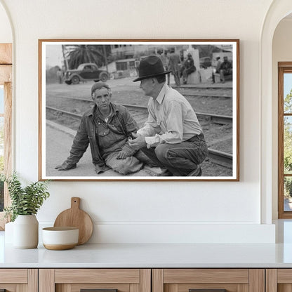 Men Seated on Railroad Platform Raymondville Texas 1939 - Available at KNOWOL