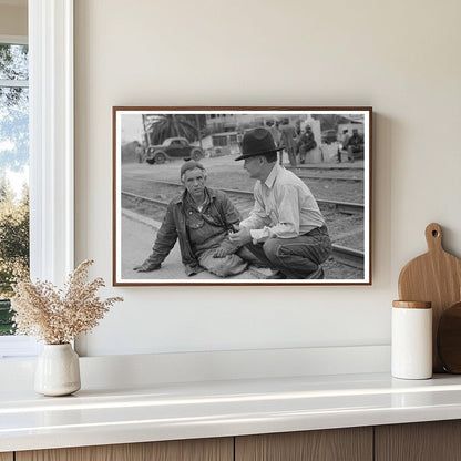 Men Seated on Railroad Platform Raymondville Texas 1939 - Available at KNOWOL