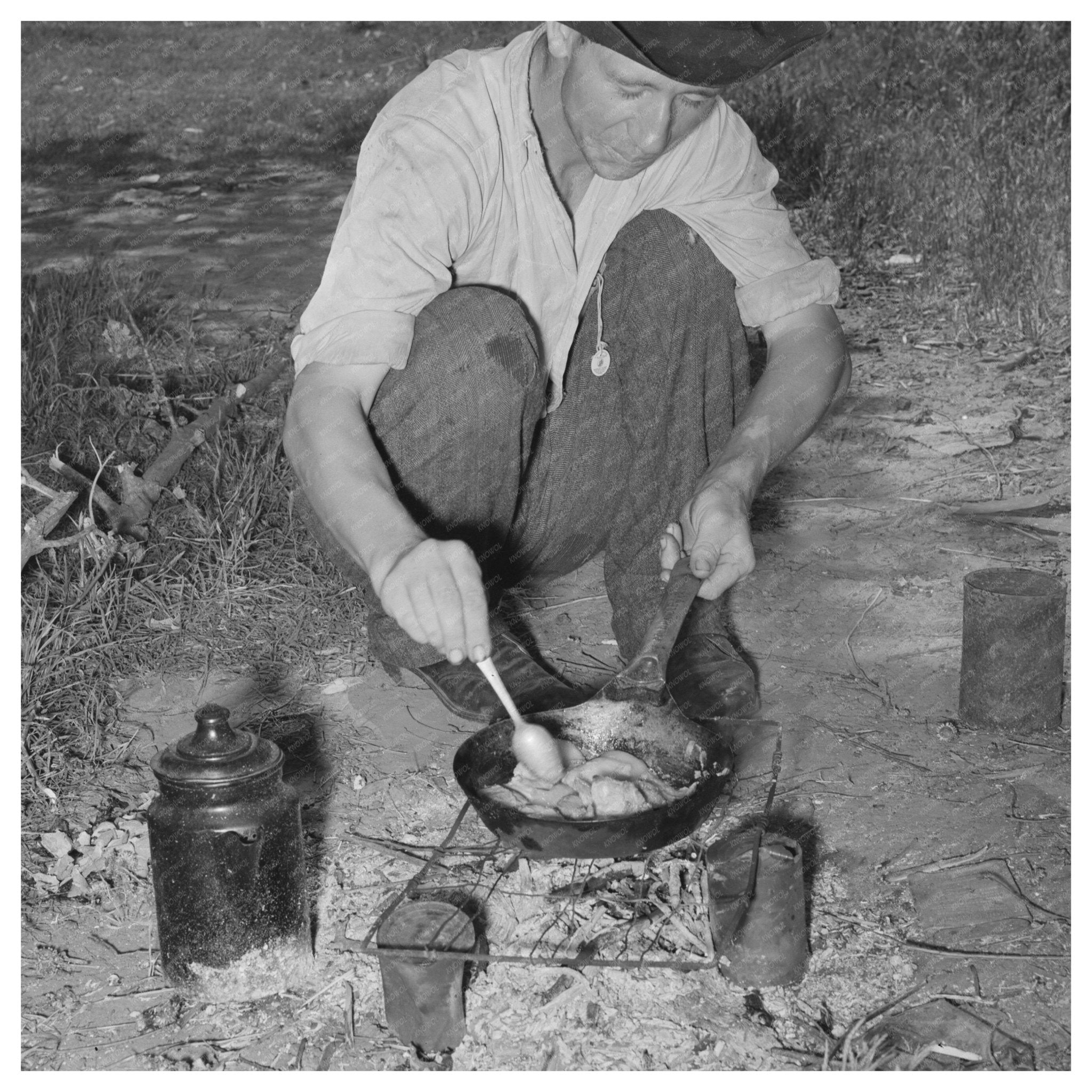 Migrant Worker Cooking Over Wood Fire June 1939 - Available at KNOWOL