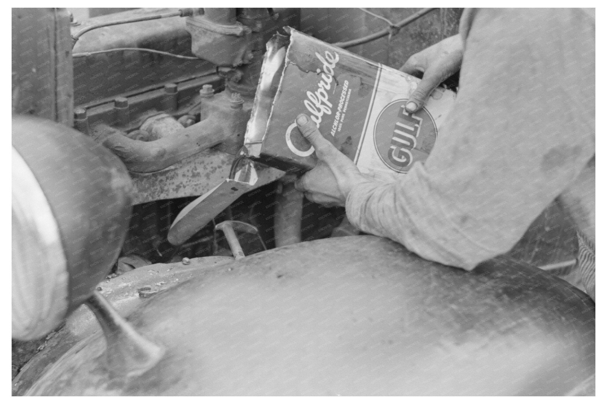 Migrant Worker Pouring Oil into Car Motor Texas 1939 - Available at KNOWOL