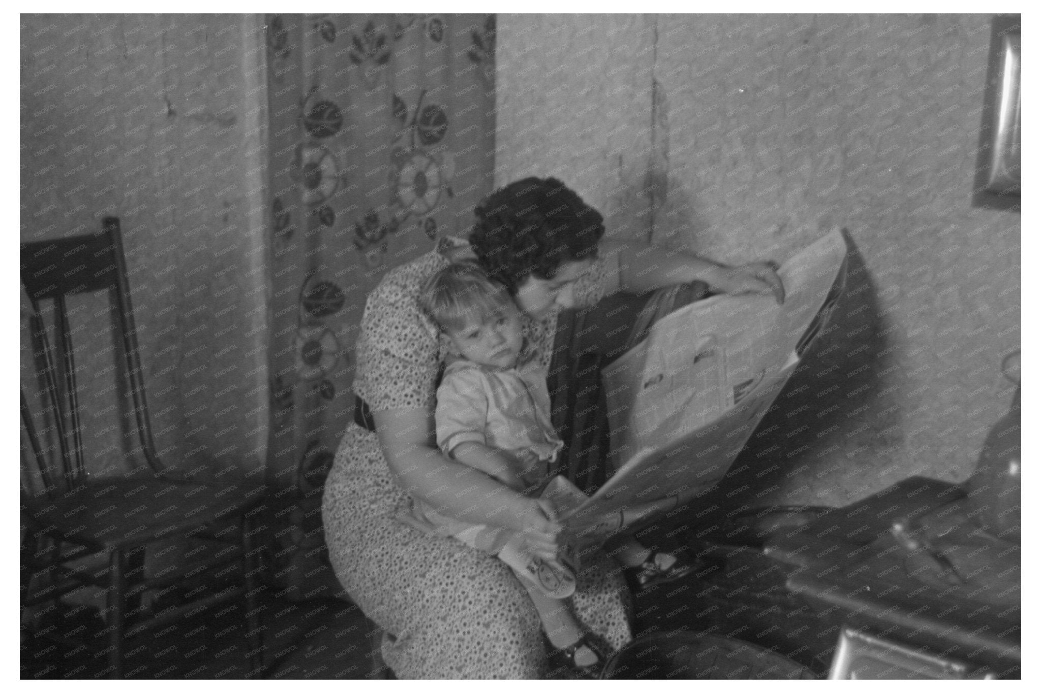 Mother Reading Newspaper with Child in Nissen Shack 1936 - Available at KNOWOL