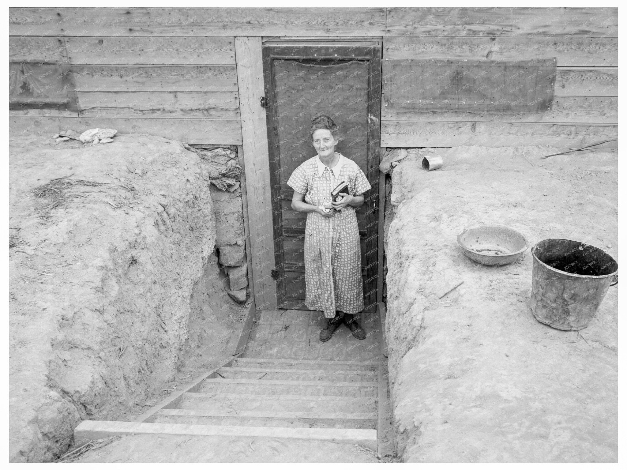 Mrs. Free in Doorway of Basement Dugout Home 1939 - Available at KNOWOL