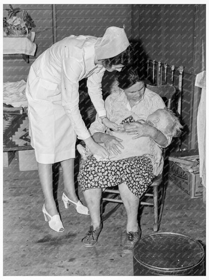 Nurse Attending Sick Infant in FSA Camp 1939 - Available at KNOWOL