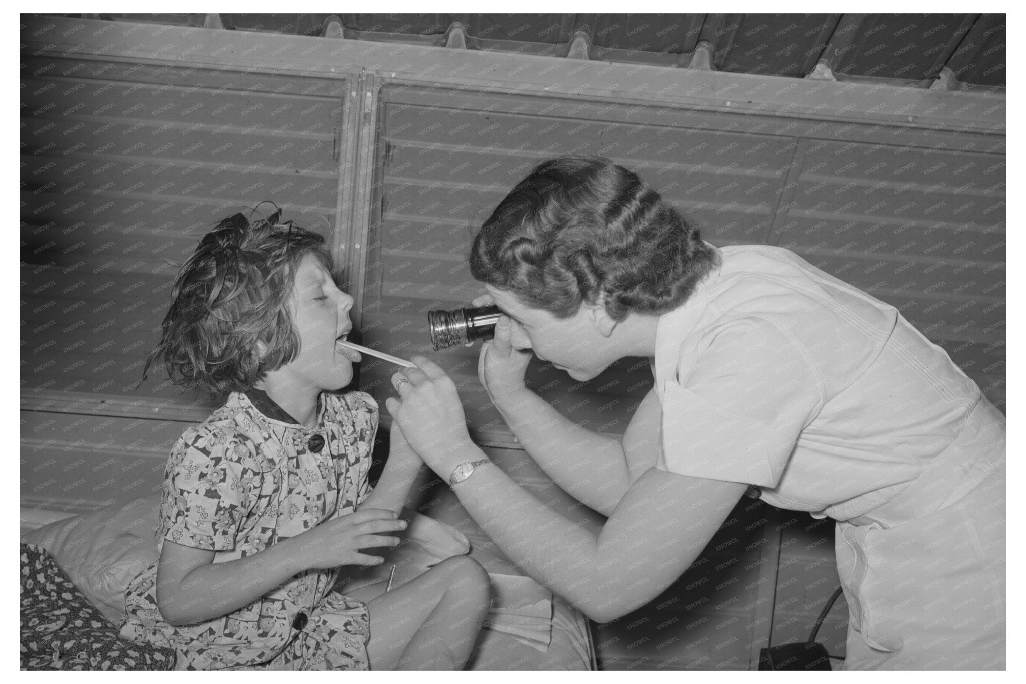 Nurse Examines Child at Agua Fria Labor Camp May 1940 - Available at KNOWOL