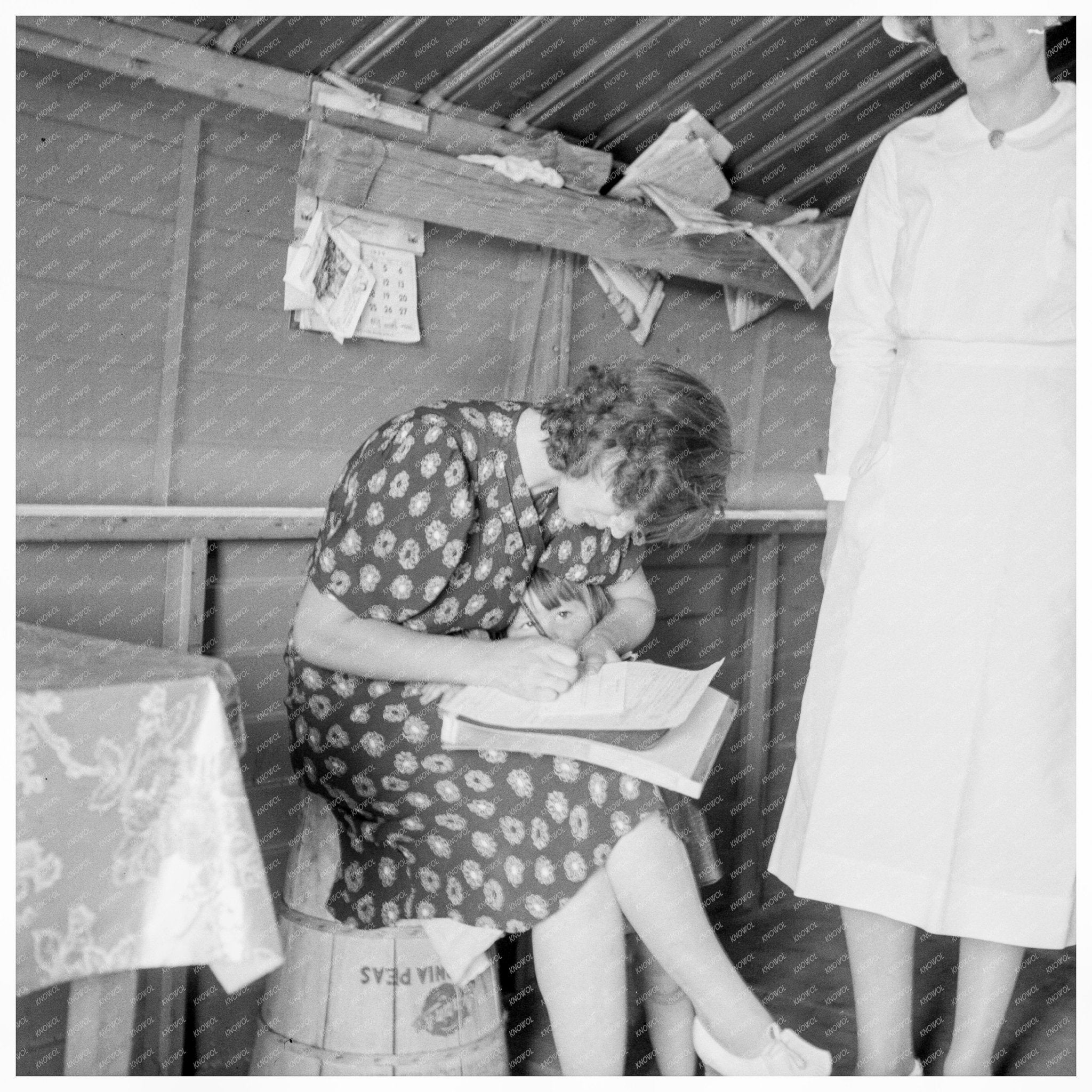 Nurse Interviewing Mother and Sick Baby May 1939 - Available at KNOWOL