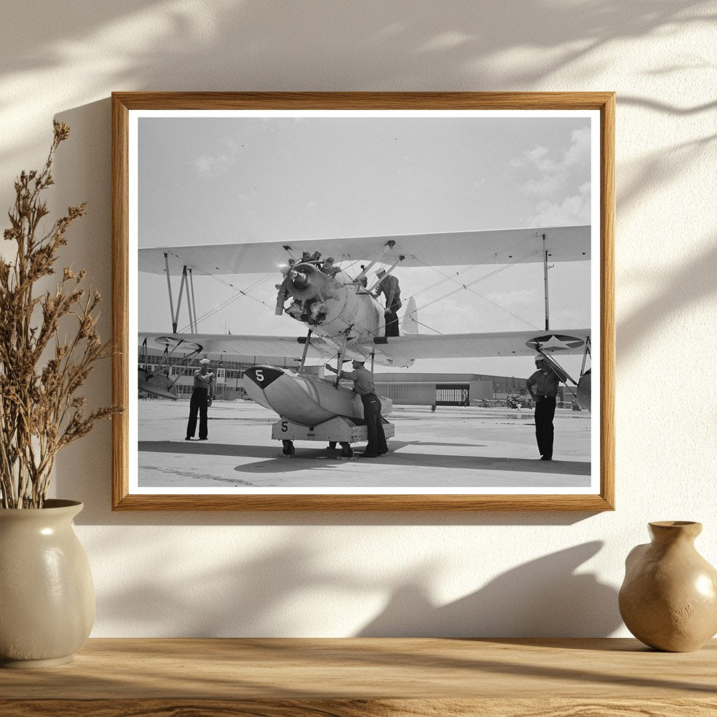 Sailor Inspects N3N Seaplane Corpus Christi August 1942 - Available at KNOWOL