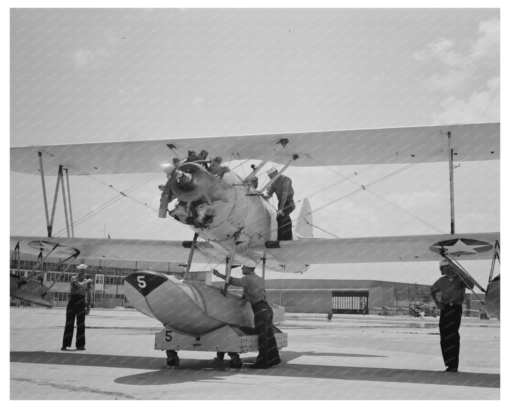 Sailor Inspects N3N Seaplane Corpus Christi August 1942 - Available at KNOWOL