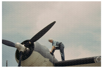 Sailor Mechanic Oil Change at Naval Air Base 1942 - Available at KNOWOL