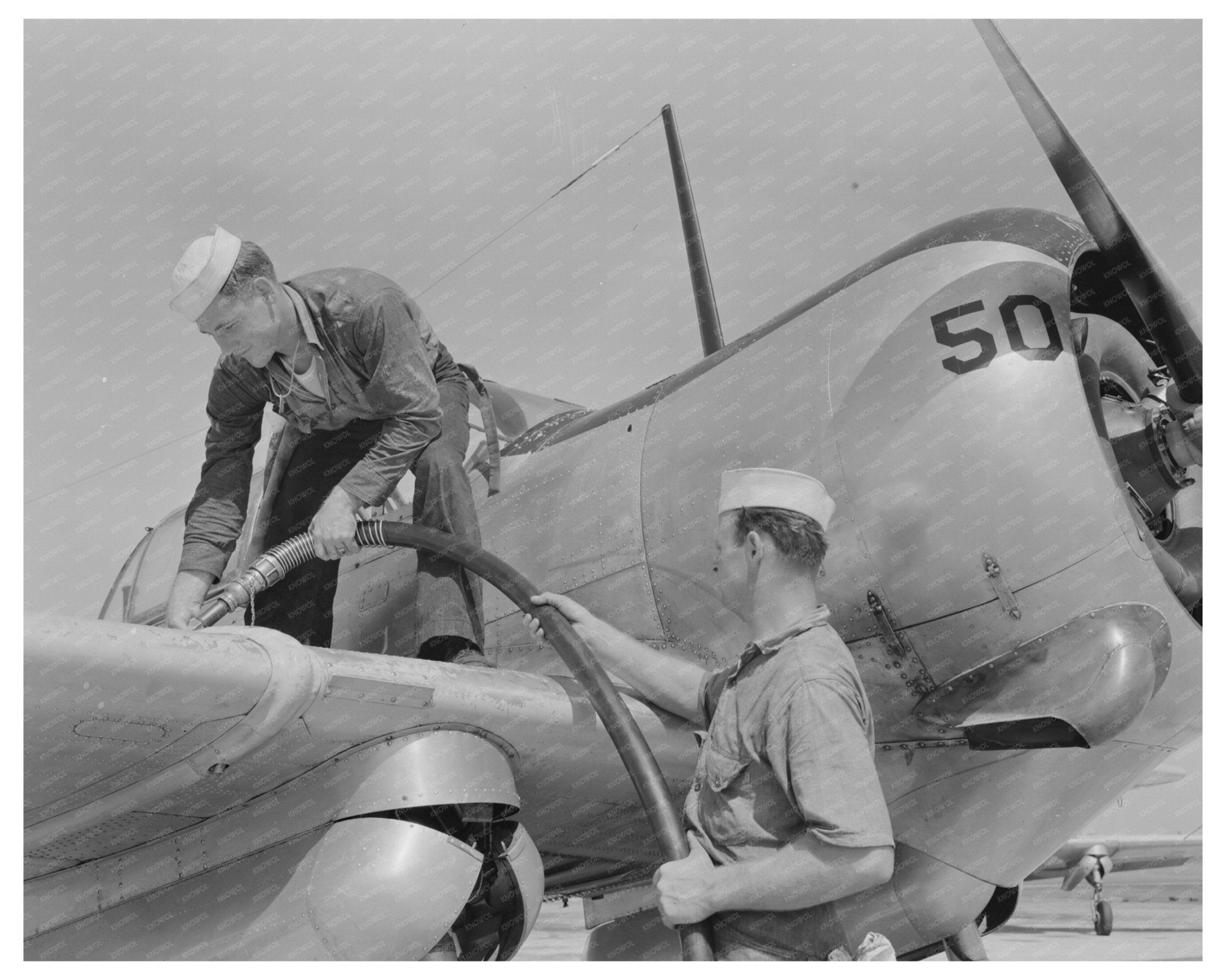 Sailor Mechanics Refueling SNC Plane in 1942 Texas - Available at KNOWOL