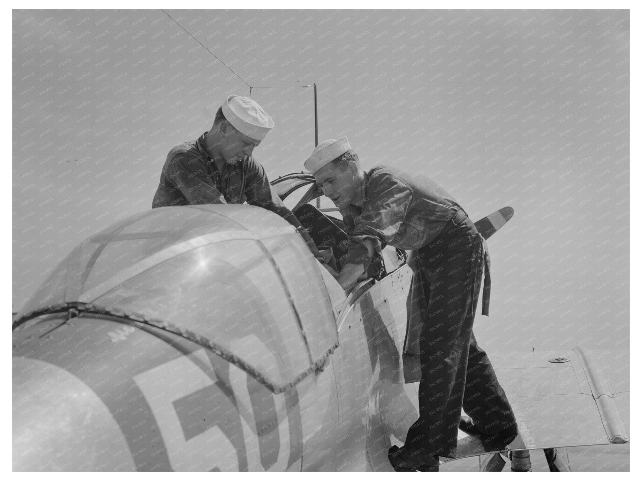 Sailors Inspect Pilot Seat of SNC Plane August 1942 - Available at KNOWOL