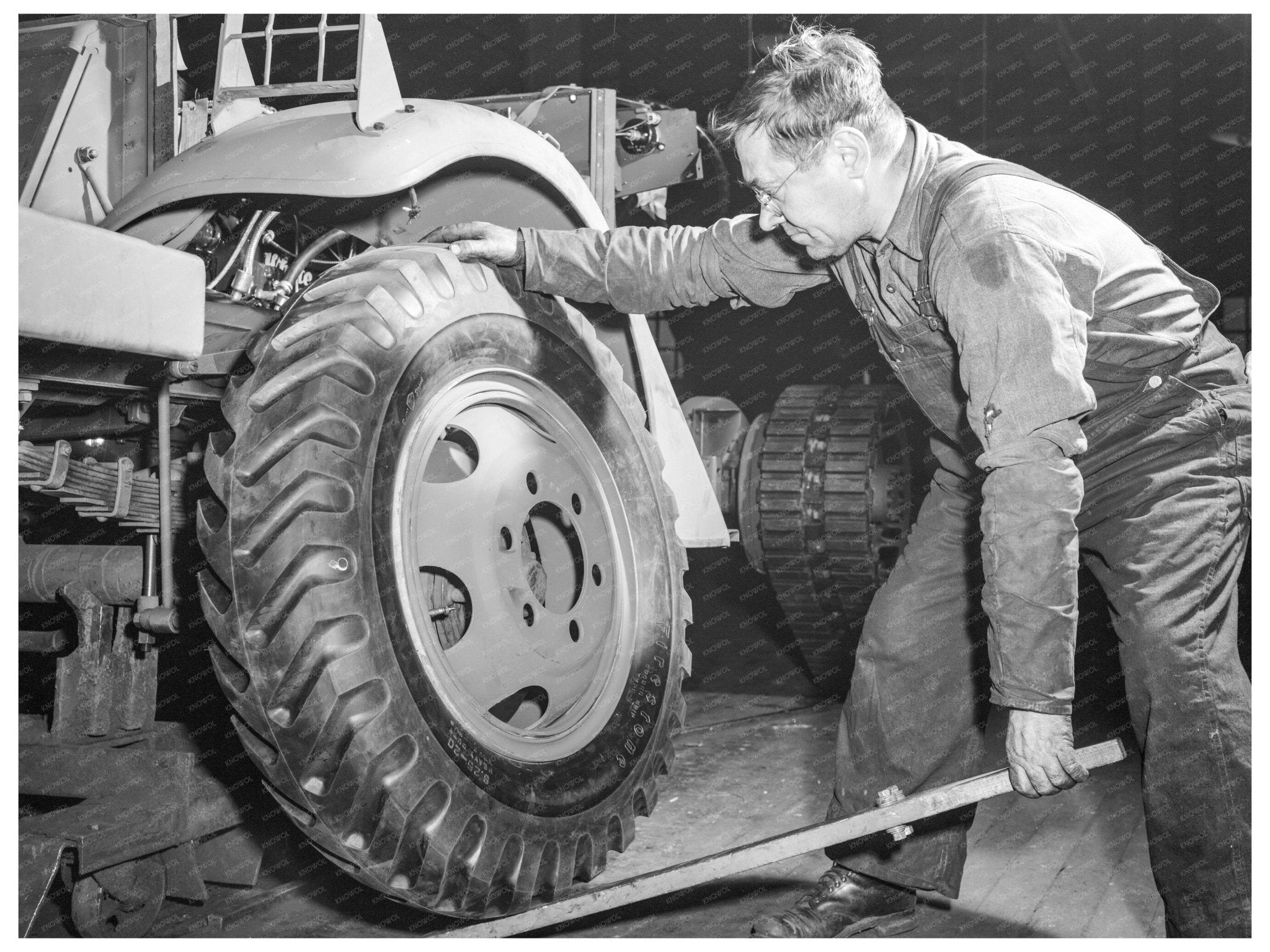 Soldier Maintaining Halftrack Scout Car December 1941 - Available at KNOWOL