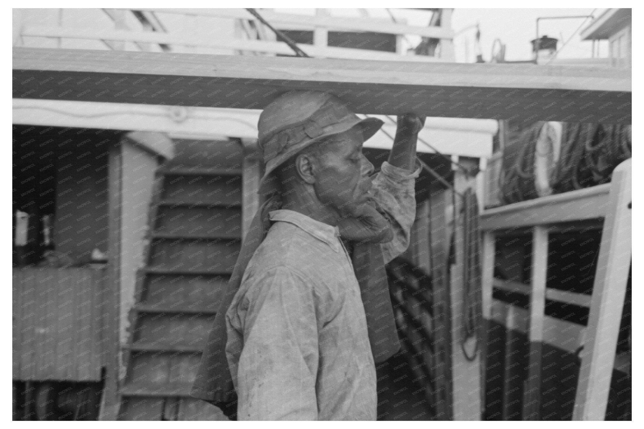 Stevedore Carrying Lumber in New Orleans 1938 - Available at KNOWOL