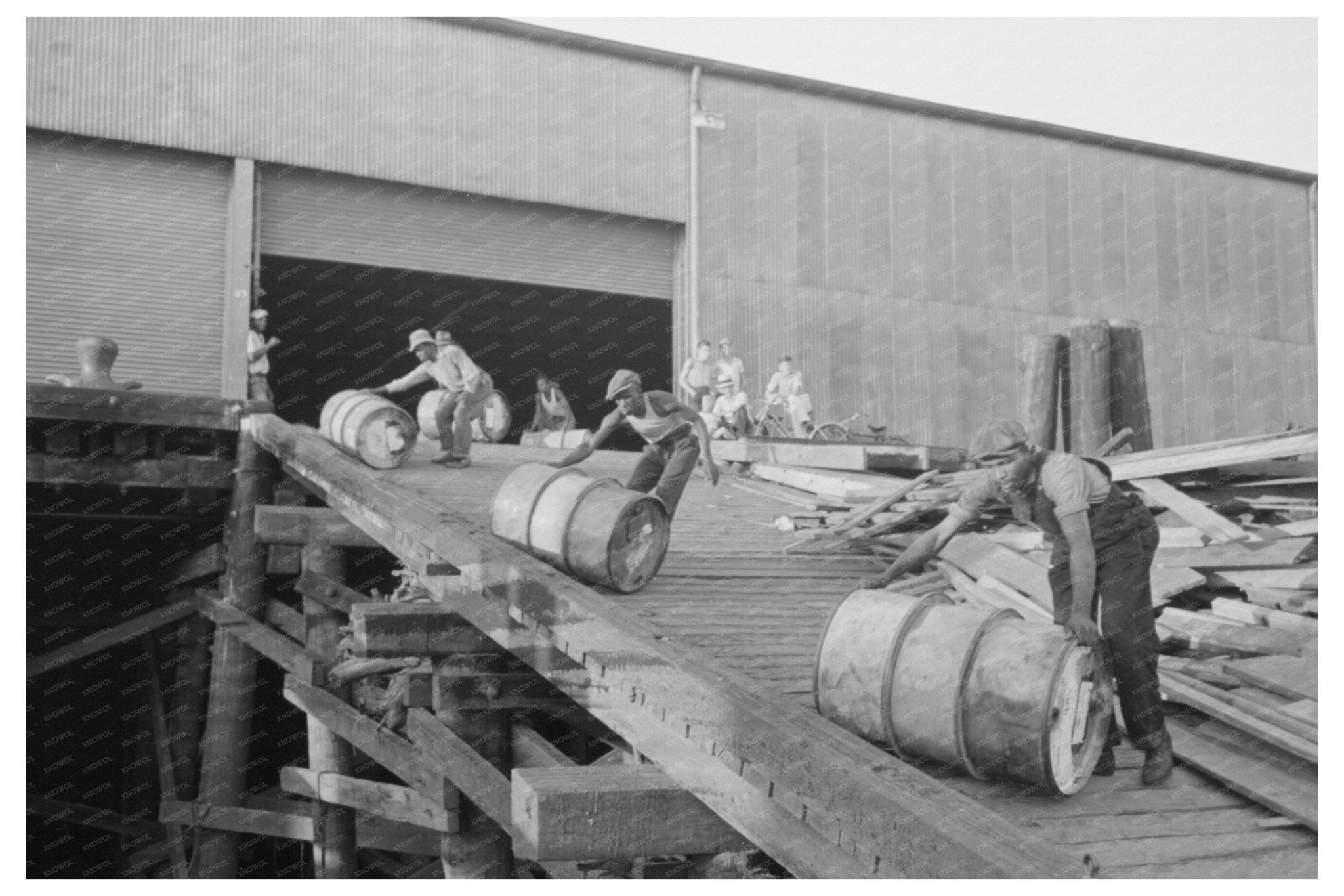 Stevedores Maneuvering Drums in New Orleans 1938 - Available at KNOWOL