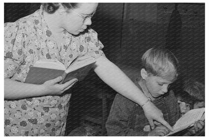 Teacher Helps Pupil with Reading in Idaho May 1941 - Available at KNOWOL