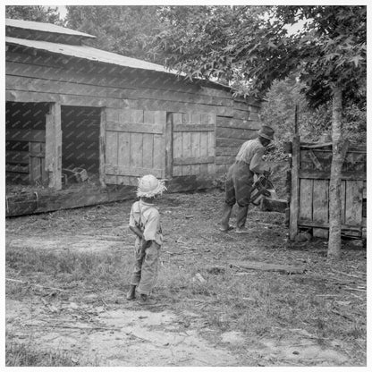 Tenant Farmer Feeding Pigs Granville County 1939 - Available at KNOWOL