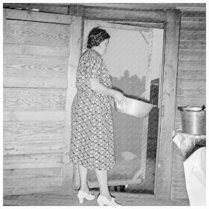 Woman Disposing Dishwater Outside Home Person County 1939 - Available at KNOWOL