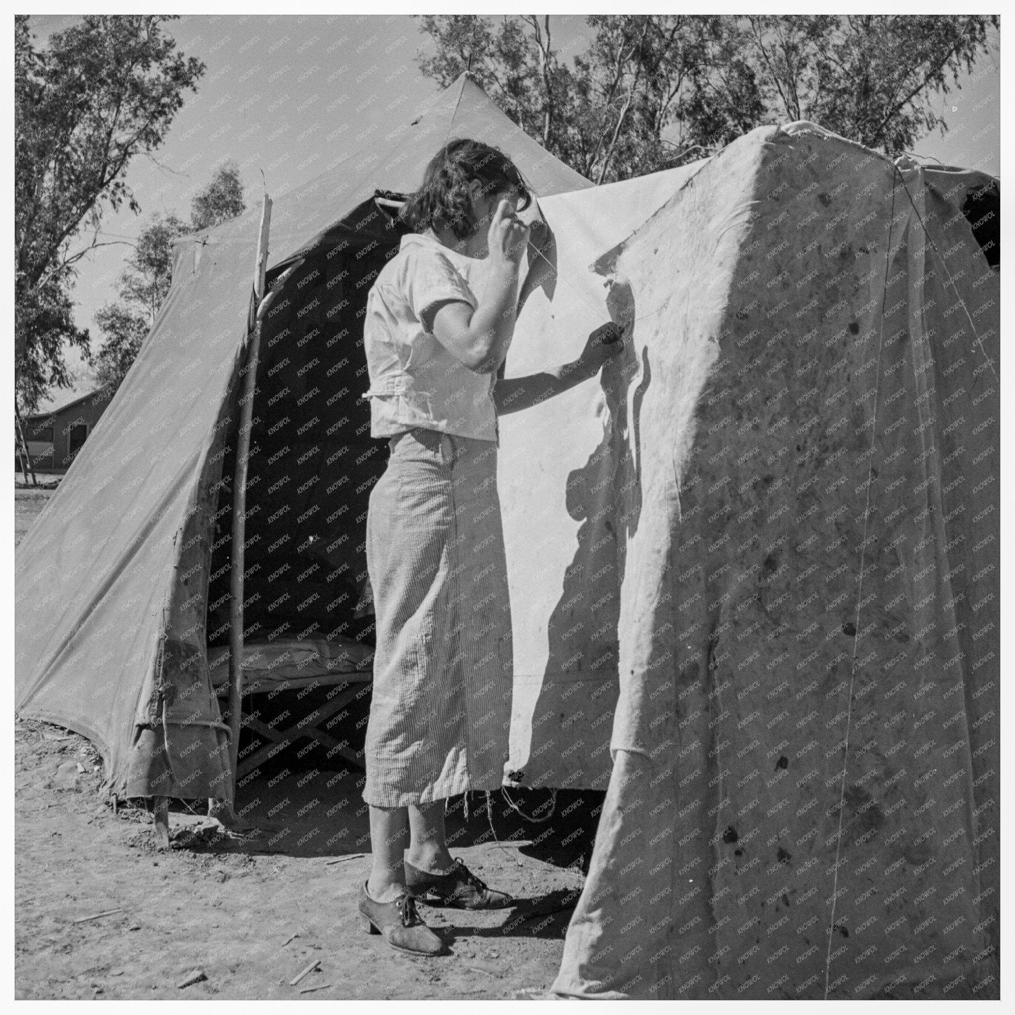 Woman Mending Tent at Pea Pickers Camp California 1937 - Available at KNOWOL