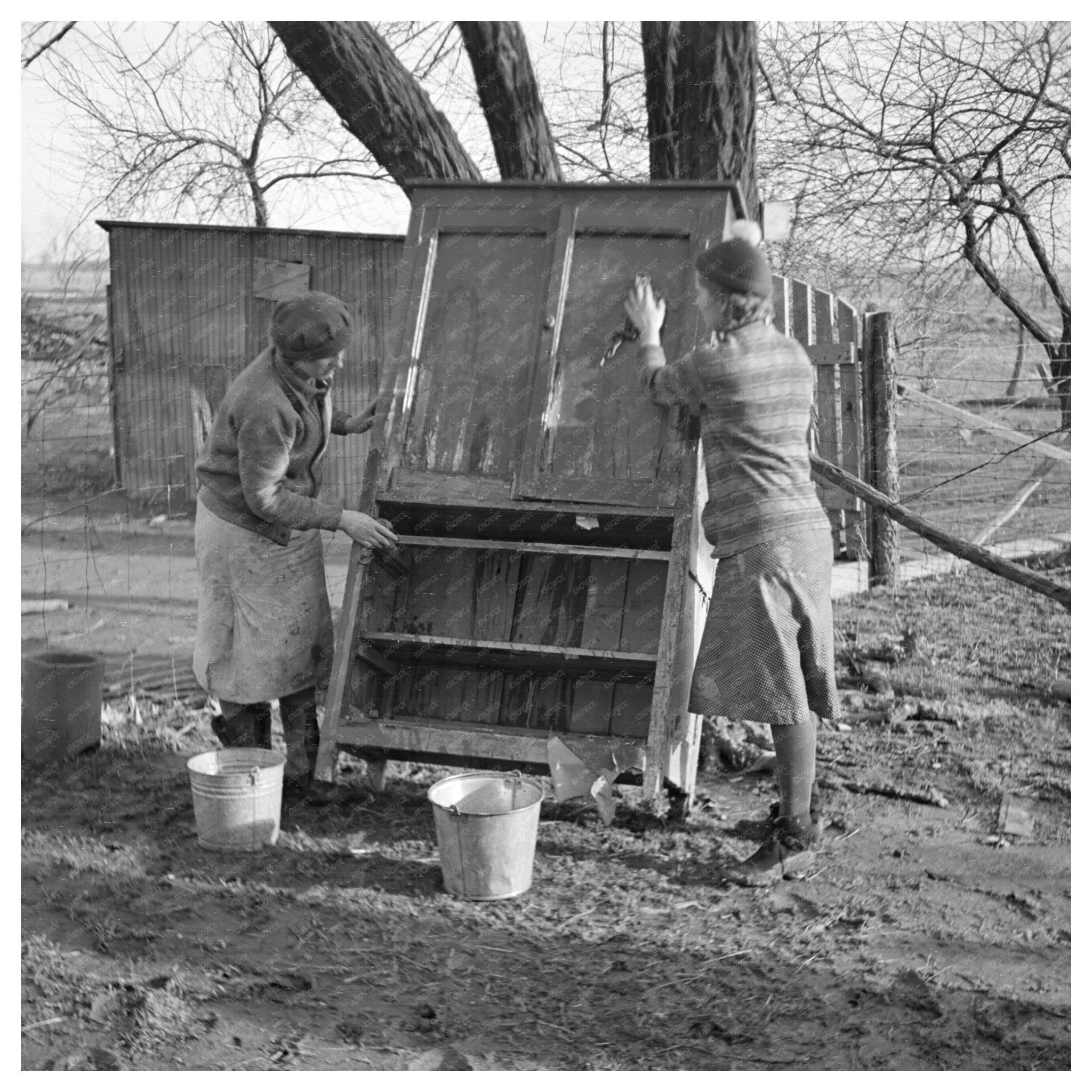 Women Cleaning Flood - Damaged Furniture in Indiana 1937 - Available at KNOWOL