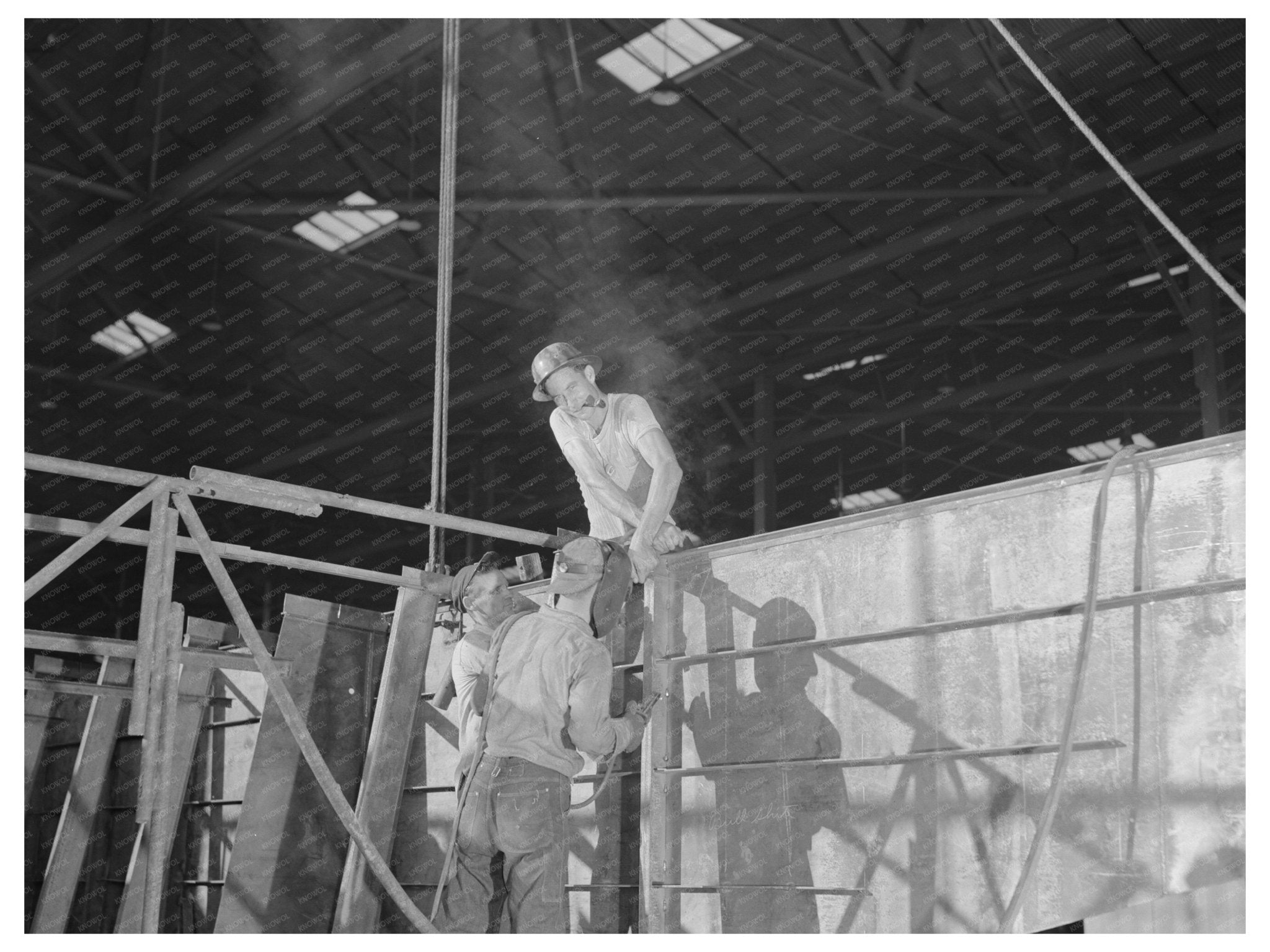 Workers Assembling Steel Ramp Boat at Higgins Industries 1942 - Available at KNOWOL