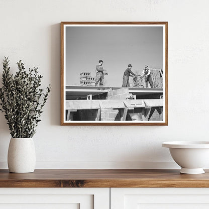 Workers Passing Cinder Blocks on Rooftop Greendale 1937 - Available at KNOWOL